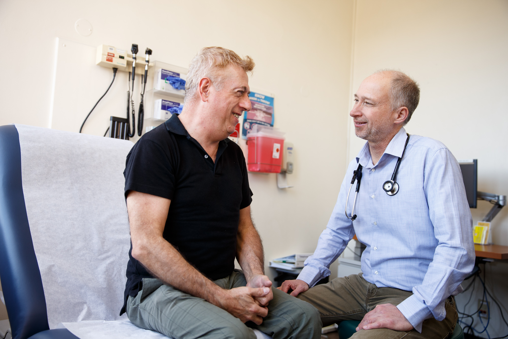 Steve Deeks, MD, talks with patient in clinic